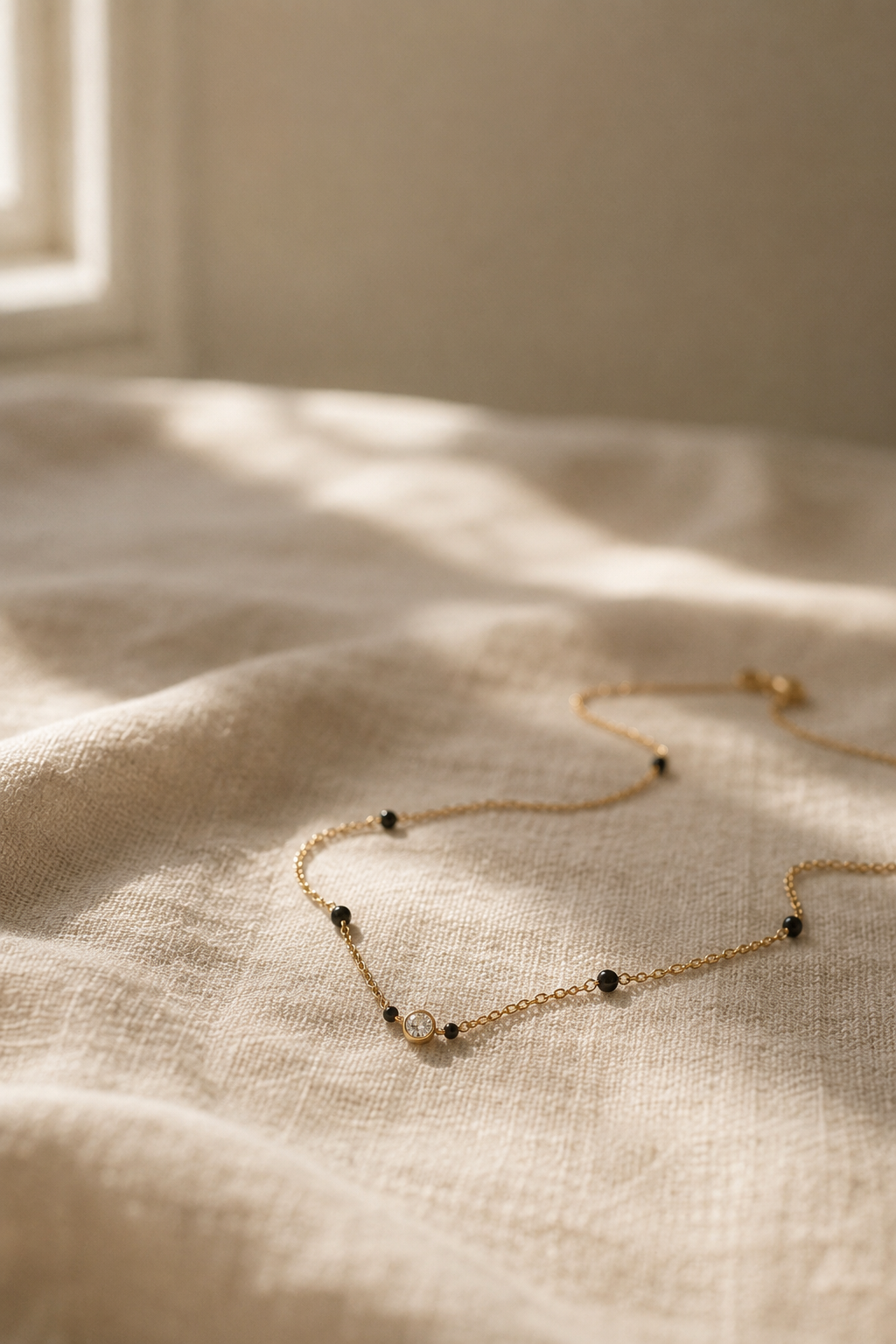 minimal mangalsutra resting on cream linen fabric