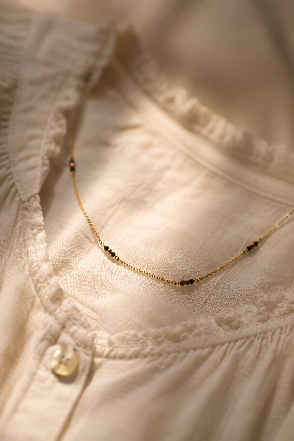 A fine mangalsutra on a womans shirt