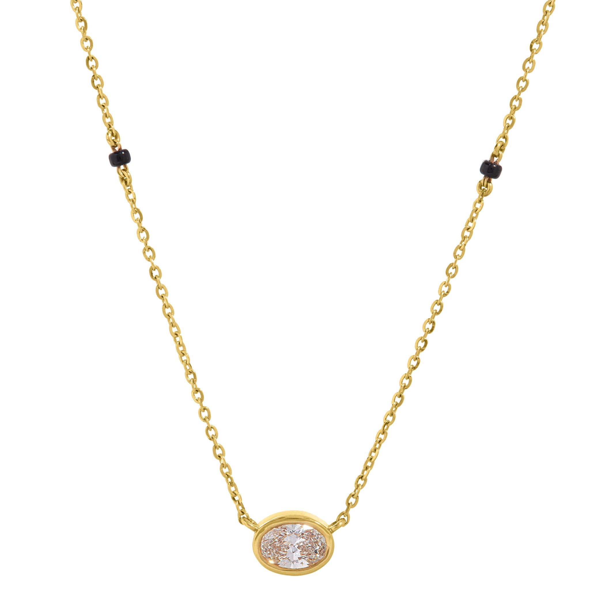 Close-up of bezel oval lab-grown diamond pendant on The Devotion mangalsutra necklace, 18k gold chain with black beads on white background