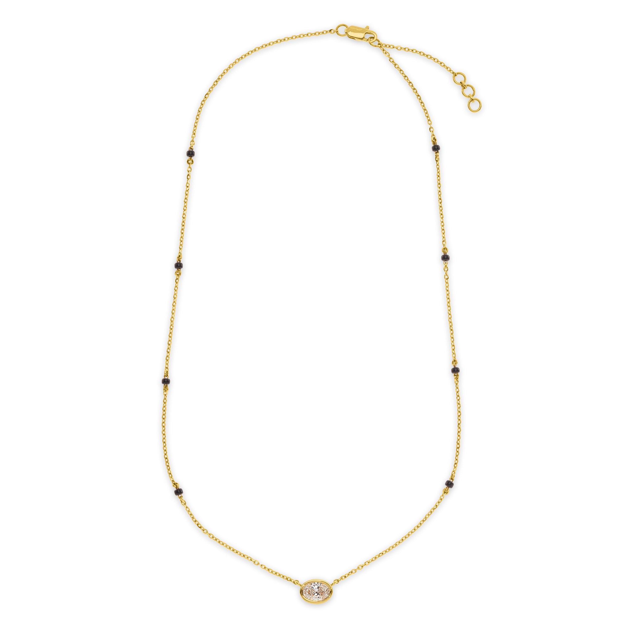The Devotionmangalsutra necklace in 18k gold with bezel set oval lab-grown diamond pendant and black beads, lobster clasp closure, on white background