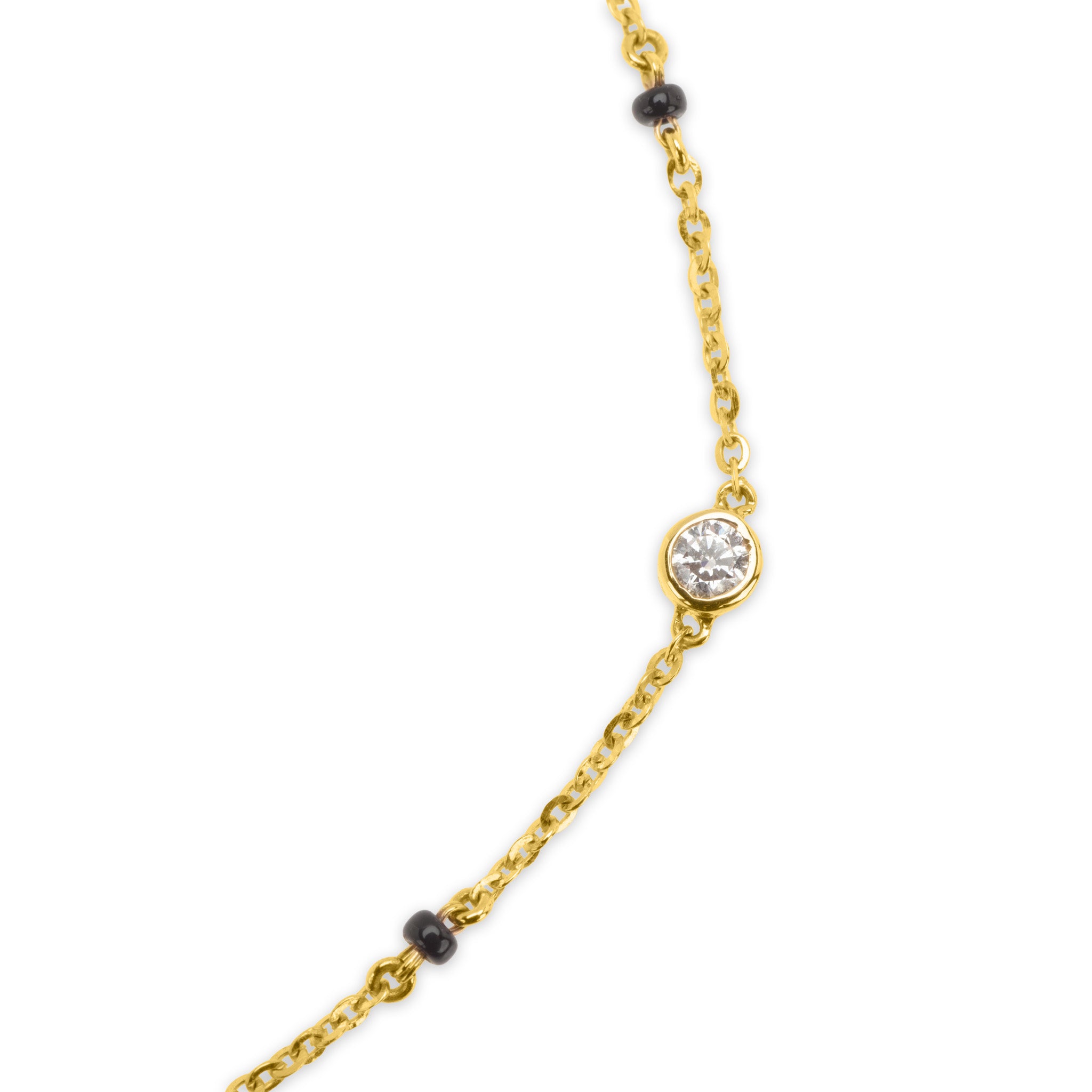 Detail of 18k gold cable chain with black bead accents and diamonds on The Unity mangalsutra necklace, on white background
