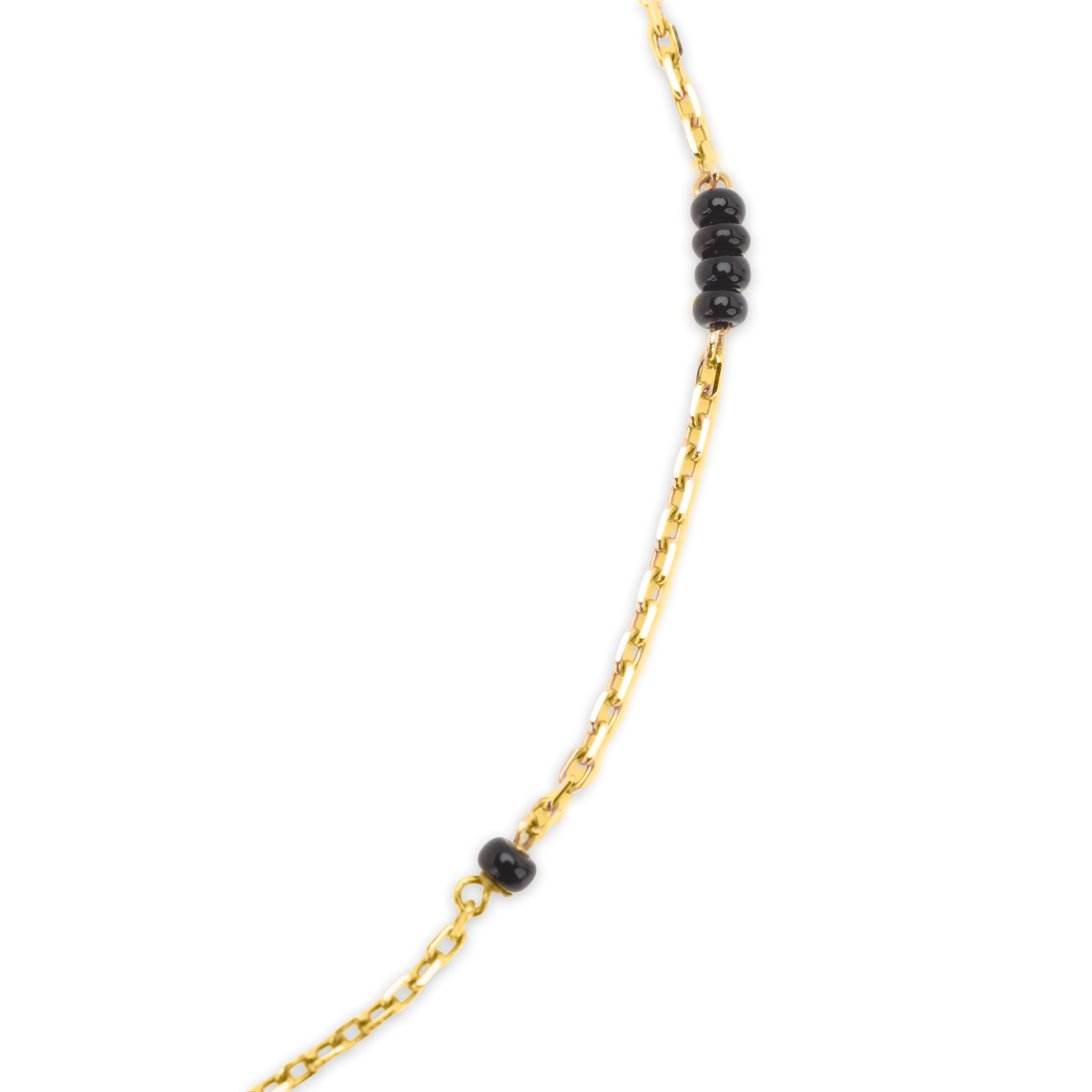 Detail of 18k gold cable chain with black bead accents on The Always mangalsutra necklace, on white background.