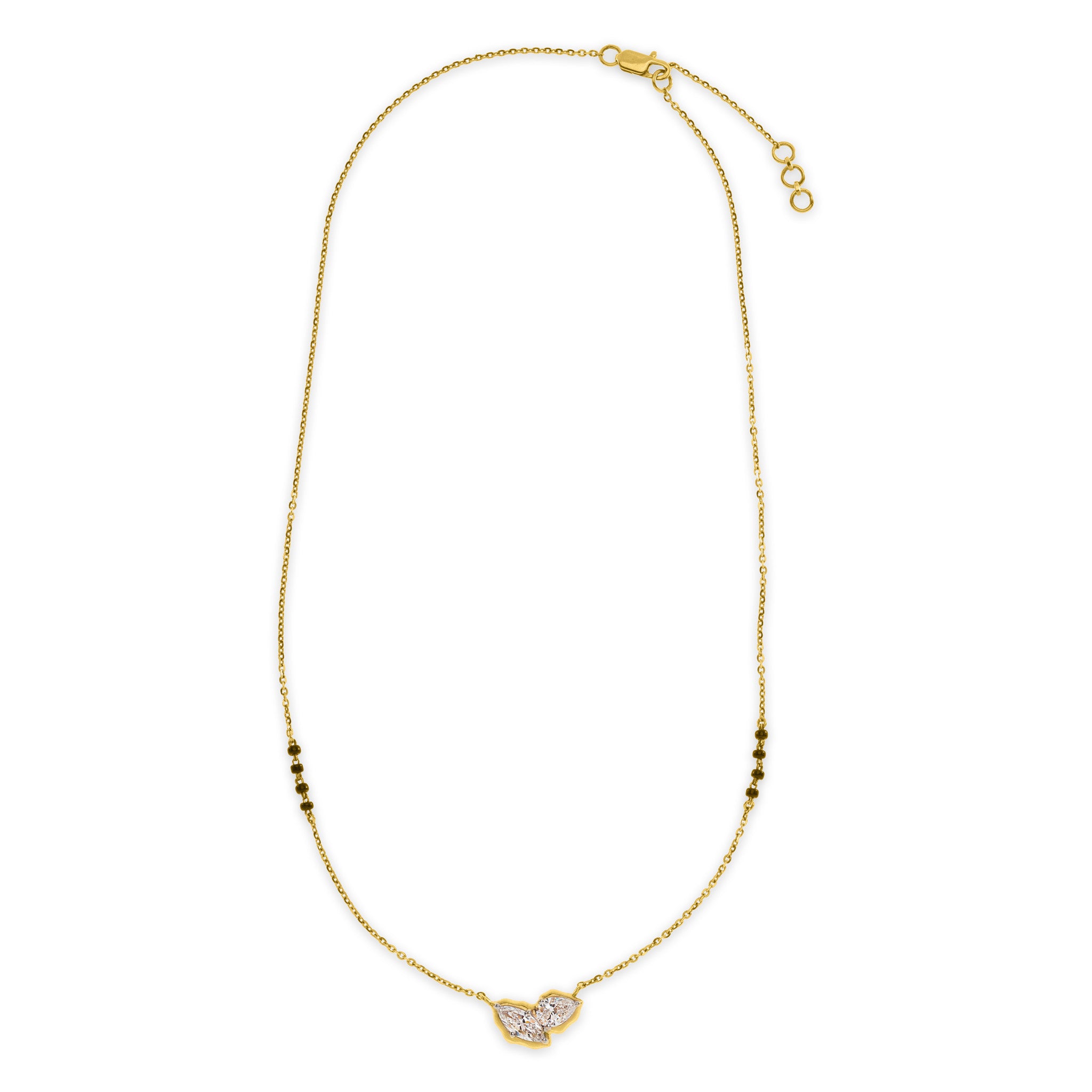 The Duet mangalsutra necklace in 18k gold with marquise and pear lab diamond pendant and black beads, lobster clasp closure, on white background.